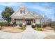 Charming home with a manicured lawn, flower beds, and inviting covered porch at 5621 Cobblestone Creek Ave # 14, Mableton, GA 30126
