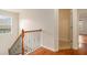 Upstairs landing featuring hardwood floors and a wood and wrought iron railing at 5621 Cobblestone Creek Ave # 14, Mableton, GA 30126