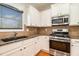 This kitchen features stainless steel appliances, granite countertops, and white cabinets at 5621 Cobblestone Creek Ave # 14, Mableton, GA 30126