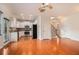 View of the kitchen with white cabinets and stainless steel appliances, seamlessly connected to the living room and staircase at 5621 Cobblestone Creek Ave # 14, Mableton, GA 30126