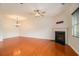 Spacious living room with hardwood floors, a fireplace, crown molding, a ceiling fan, and ample natural light at 5621 Cobblestone Creek Ave # 14, Mableton, GA 30126