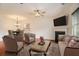 Staged living room with fireplace, ceiling fan, modern furniture, and dining area at 5621 Cobblestone Creek Ave # 14, Mableton, GA 30126