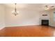 Open-concept living room with hardwood floors, fireplace, chandelier, ceiling fan, and bright natural light at 5621 Cobblestone Creek Ave # 14, Mableton, GA 30126