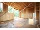 Interior framing of home with wood beams, walls, and window opening looking into wooded yard at 578 Price Rd, Carrollton, GA 30116