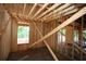 An interior view of the new home under construction shows a wood frame and window openings to outside at 578 Price Rd, Carrollton, GA 30116