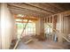 An interior view of the new home under construction shows a wood frame and view to the yard at 578 Price Rd, Carrollton, GA 30116