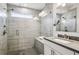 Modern bathroom featuring a walk-in shower with dual showerheads and sleek vanity with ample counter space at 1174 City Park Ln, Decatur, GA 30033