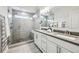 Modern bathroom with dual sinks, gray countertops, and a glass-enclosed shower at 1174 City Park Ln, Decatur, GA 30033