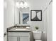 Clean bathroom featuring a white vanity with a gray countertop, a mirror, and modern lighting at 1174 City Park Ln, Decatur, GA 30033