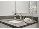 Modern bathroom with gray countertop vanity with sink, towel, and soap at 1174 City Park Ln, Decatur, GA 30033