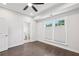 Bright bedroom featuring hardwood floors, neutral paint, a ceiling fan, and natural light at 1174 City Park Ln, Decatur, GA 30033