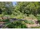 Raised bed community garden area in Medlock Park with lush vegetation and plenty of greenery and sunlight at 1174 City Park Ln, Decatur, GA 30033