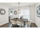 Dining area with modern lighting fixture, hardwood floors, and neutral decor at 1174 City Park Ln, Decatur, GA 30033
