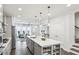 Spacious kitchen with an island, stainless steel appliances, and hardwood floors adjacent to a living area at 1174 City Park Ln, Decatur, GA 30033