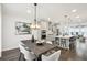 Open-concept kitchen and dining area with modern appliances, island, and lighting at 1174 City Park Ln, Decatur, GA 30033