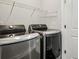 Laundry room with side-by-side washer and dryer in metallic finish and white wire shelving at 1174 City Park Ln, Decatur, GA 30033