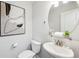 Elegant powder room with contemporary fixtures, stylish mirror, and tasteful artwork at 1174 City Park Ln, Decatur, GA 30033