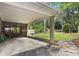 Exterior shot showcasing the backyard with a covered porch, lush lawn, and mature trees, creating a relaxing outdoor space at 2180 Howell Mill Nw Rd, Atlanta, GA 30318