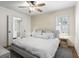 Serene bedroom with a neutral color palette, wood accent wall, and ample natural light at 2180 Howell Mill Nw Rd, Atlanta, GA 30318