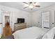 Bright bedroom featuring hardwood floors, neutral decor, and access to ensuite bathroom at 2180 Howell Mill Nw Rd, Atlanta, GA 30318