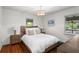 Cozy bedroom featuring hardwood floors, a comfortable bed, and warm lighting, creating a relaxing atmosphere at 2180 Howell Mill Nw Rd, Atlanta, GA 30318