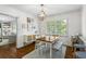 Inviting dining room features hardwood floors, white trim, natural light, and flows into the living room at 2180 Howell Mill Nw Rd, Atlanta, GA 30318