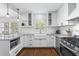 Bright kitchen with white cabinetry, stainless steel appliances, farmhouse sink, and hardwood floors at 2180 Howell Mill Nw Rd, Atlanta, GA 30318