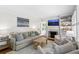 Bright living room features a fireplace, built-in shelving, neutral furniture, and shuttered windows at 2180 Howell Mill Nw Rd, Atlanta, GA 30318