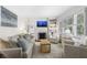 Cozy living room featuring a fireplace, built-in shelving, neutral furniture, and shuttered windows at 2180 Howell Mill Nw Rd, Atlanta, GA 30318