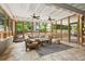 Enclosed porch offering an inviting outdoor living space with a comfortable seating area and natural light at 2180 Howell Mill Nw Rd, Atlanta, GA 30318