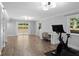 Finished basement with wood floors, light grey walls, desk space and a slider that exits to the yard at 2445 Kings Point Dr, Dunwoody, GA 30338