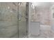 Luxurious bathroom with marble tile, glass shower, and soaking tub at 2445 Kings Point Dr, Dunwoody, GA 30338