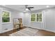 Bright bedroom with a vanity, a neutral rug, hardwood floors, and natural lighting at 2445 Kings Point Dr, Dunwoody, GA 30338