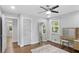 Well-lit bedroom featuring hardwood floors, a modern vanity, and bright windows at 2445 Kings Point Dr, Dunwoody, GA 30338