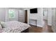 Bright bedroom with hardwood floors, closet, and modern table; perfect for relaxation at 2445 Kings Point Dr, Dunwoody, GA 30338
