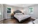 Cozy bedroom featuring patterned wallpaper, hardwood floors, and bright natural light at 2445 Kings Point Dr, Dunwoody, GA 30338