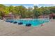 Large community pool area with ample seating, lap lanes and well maintained grounds at 2445 Kings Point Dr, Dunwoody, GA 30338