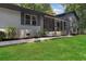 Beautifully renovated home with a light gray brick exterior, modern railings, and a well-maintained lawn at 2445 Kings Point Dr, Dunwoody, GA 30338