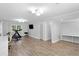 Spacious home gym with workout equipment, wall-mounted TV, and ample lighting at 2445 Kings Point Dr, Dunwoody, GA 30338