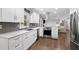 Stylish kitchen with white cabinets, stainless steel appliances, and a seamless transition to the living areas at 2445 Kings Point Dr, Dunwoody, GA 30338