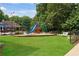 Community playground featuring a colorful slide, swings and lush green lawn at 2445 Kings Point Dr, Dunwoody, GA 30338