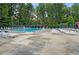 Community pool with chairs and umbrellas and plenty of seating for residents at 2445 Kings Point Dr, Dunwoody, GA 30338