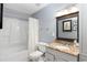 Clean bathroom features granite counters, bathtub with shower, and lots of lighting for a refreshing experience at 303 Gettysburg Pl, Atlanta, GA 30350