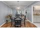 Cozy dining area featuring wood floors and a unique mirrored accent wall at 303 Gettysburg Pl, Atlanta, GA 30350