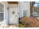 Charming front door of a light gray home with an inviting floral wreath at 303 Gettysburg Pl, Atlanta, GA 30350