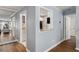 Hallway featuring hardwood floors, white trim, and view into kitchen at 303 Gettysburg Pl, Atlanta, GA 30350
