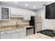 Well-lit kitchen featuring granite countertops, stainless steel appliances, and white cabinets at 303 Gettysburg Pl, Atlanta, GA 30350