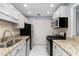 Well-organized kitchen featuring modern appliances, white cabinets and granite countertops at 303 Gettysburg Pl, Atlanta, GA 30350