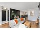 Open-concept living space with hardwood floors, stylish decor, and seamless flow into dining area is designed for modern living at 303 Gettysburg Pl, Atlanta, GA 30350