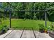 Lush backyard with a black pergola, green grass, and a view of the surrounding trees at 3234 Baymount Way, Lawrenceville, GA 30043